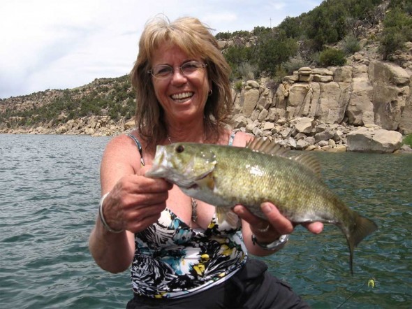 Peggy Harrell shows off a nice Smallmouth bass from Navajo Lake, New Mexico.