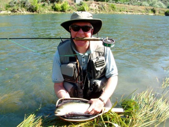 Tim McCarthy of Albuquerque shows off a fine trout caught in the improved habitat area of the San Juan River  below Simon Canyon.