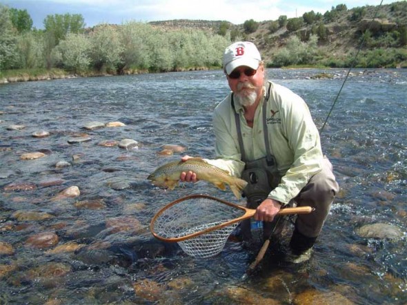 Larry Johnson and a nice San Juan River Brown trout caught at Soaring Eagle Lodge.