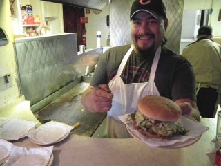 Cook, Richard Beltran, serves up another legendary green, chile cheeseburger at the Owl Bar and cafe in San Antonio, New Mexico.