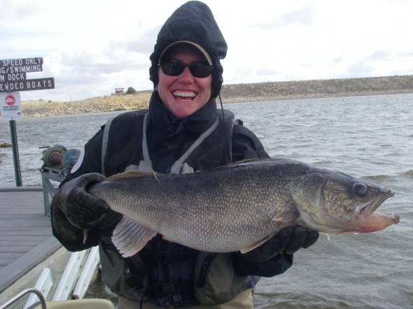 Former NM Dept. of Game and Fish Conservation Officer, Kelly Dobbs, shows off a record breaking walleye discovered in Clayton lake State Park in 2010.