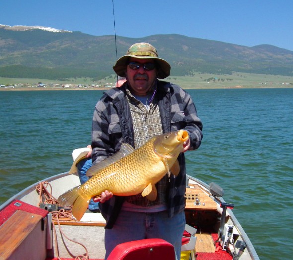 Toby Varos of Taos shows off a nice carp he picked up while fishing  at Eagle Nest Lake in the spring of 2012.
