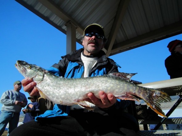 Steve Hesch, 51, of Los Alamos shows of a pike he caught during a Feb. 2012 ice fishing derby at Eagle Nest Lake.