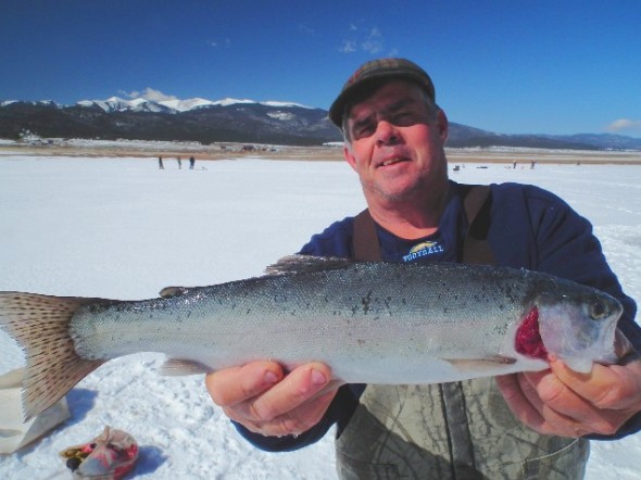 Mitch Roggy, 53, of Albuquerque shows off a nice, fat Rainbow trout he picked  up while ice fishing at Eagle Nest Lake one past winter.