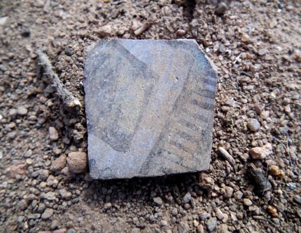 A pottery shard found in the dirt among the ruins of an Indian settlement on Burnt Mesa at Bandelier National Monument in New Mexico.